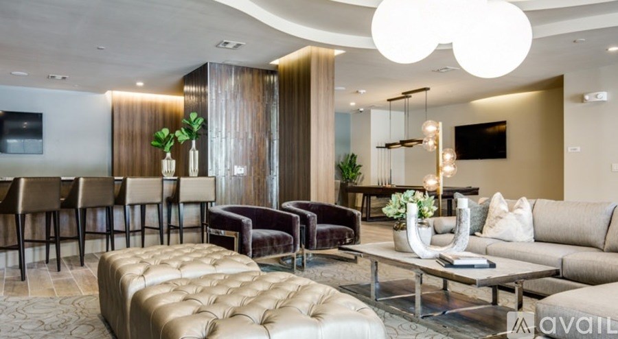 A modern living room with a variety of seating options and a large coffee table.