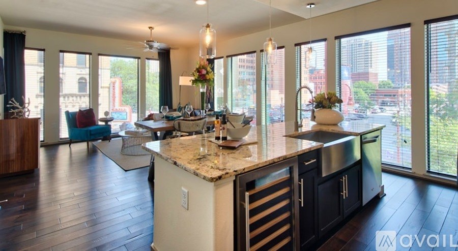 A kitchen with a marble countertop and a view of the city.