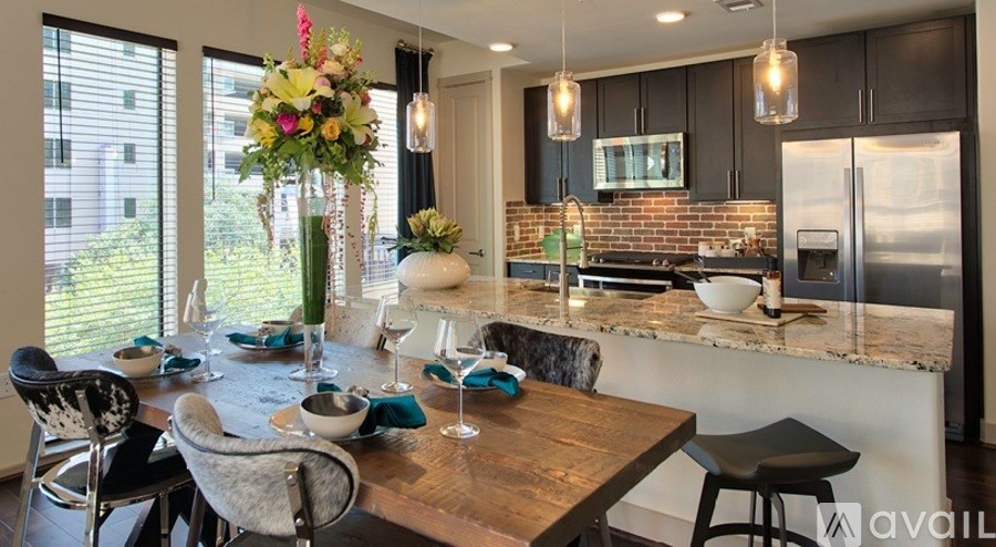 A kitchen with a table set for a meal.