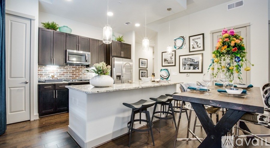 A kitchen with a white island and a dining table set for four.