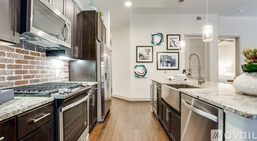 A kitchen with a stove top oven and a refrigerator.