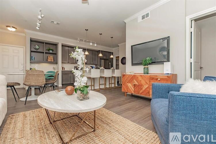 A living room with a white coffee table and a blue couch.