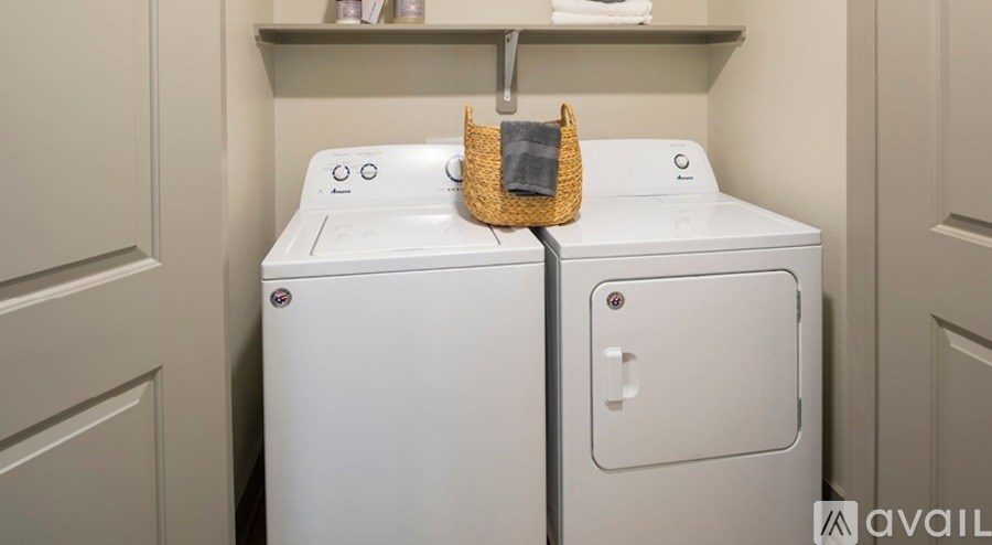 A white washing machine and dryer in a laundry room.