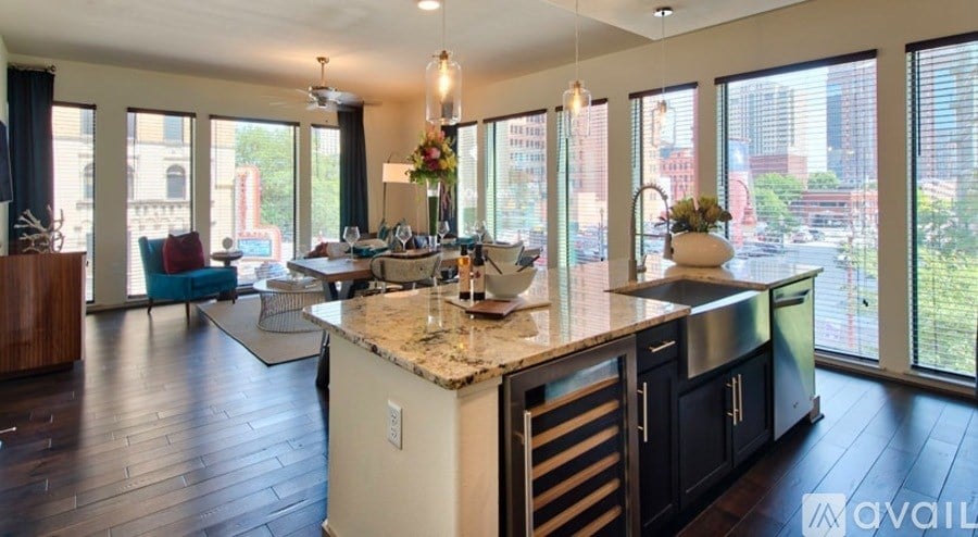 A kitchen with a marble countertop and a view of the city.