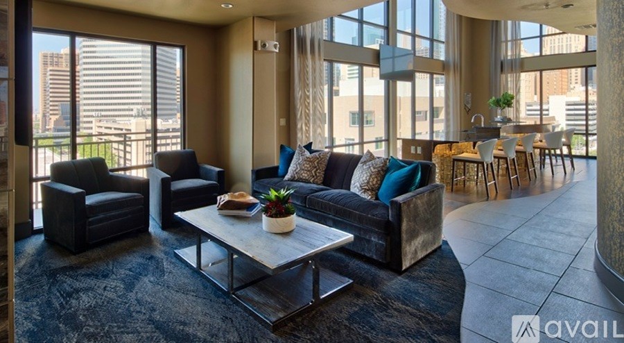 A living room with a large window and a view of the city.
