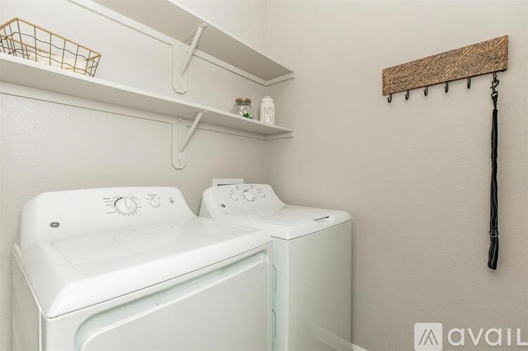 A white washing machine and dryer in a small laundry room.