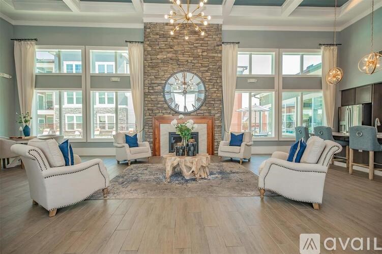 A living room with a fireplace and a large clock on the wall.
