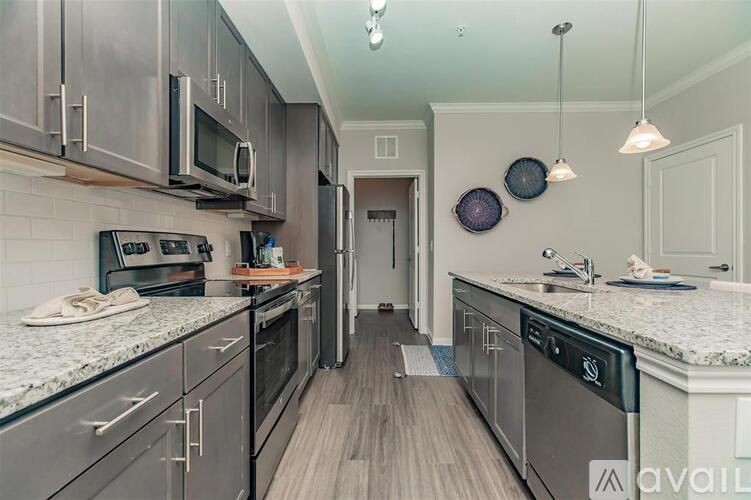 A kitchen with dark wood cabinets and granite countertops.