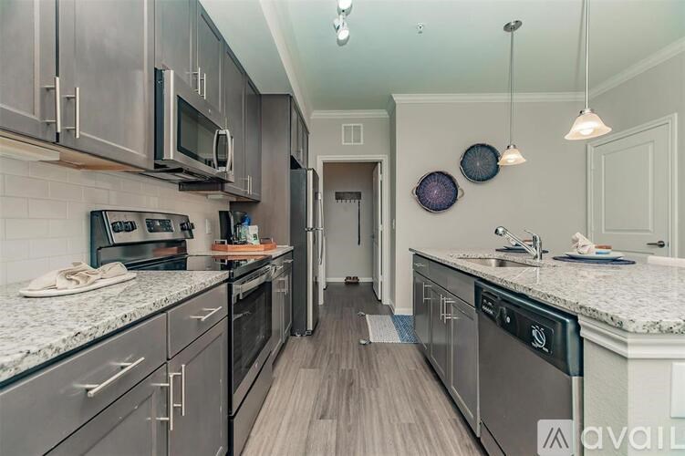 A kitchen with dark wood cabinets and granite countertops.