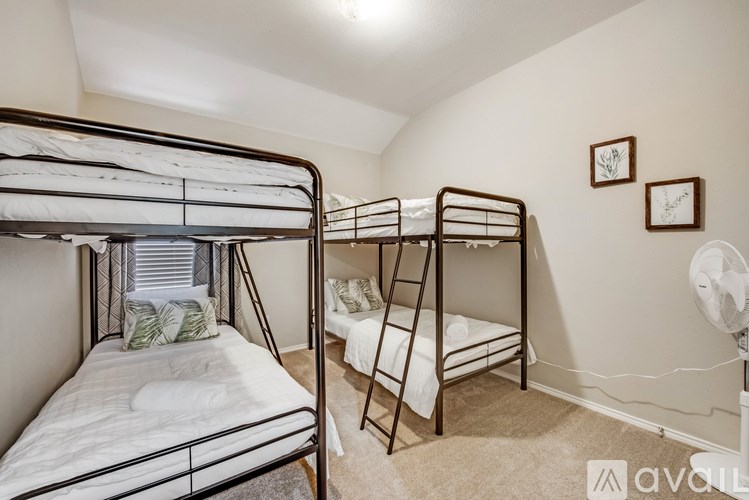 A room with two bunk beds and a ladder.