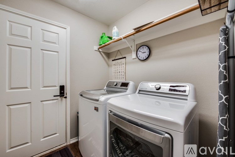 A small laundry room with a washer and dryer.