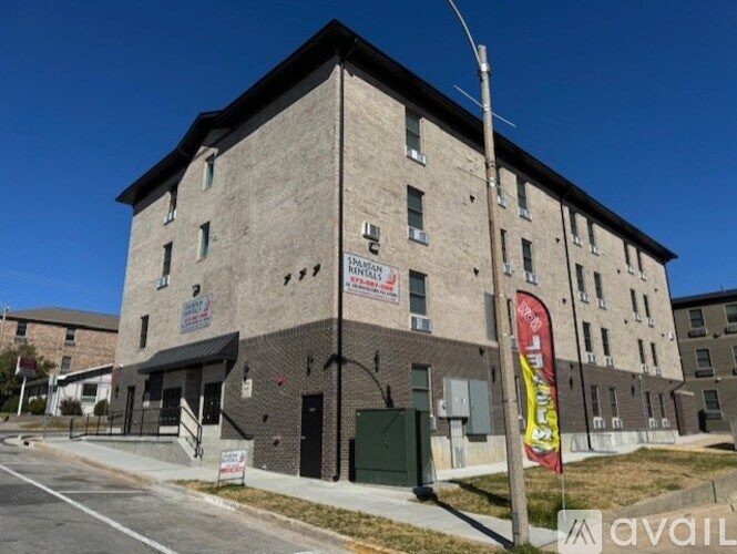 A building with a sign that says "AVAILABLE" in front of it.