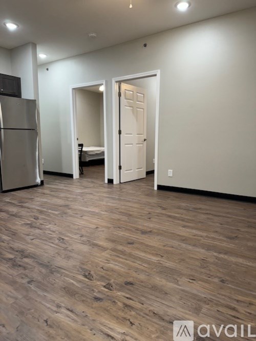 A room with a wooden floor and a white door.