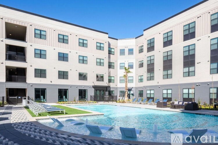 A large building with a pool in front of it.