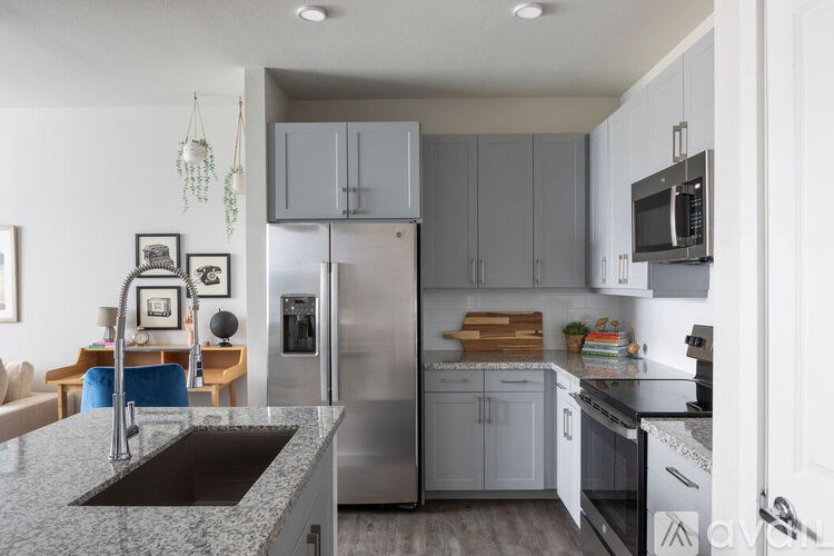A modern kitchen with stainless steel appliances and a granite countertop.