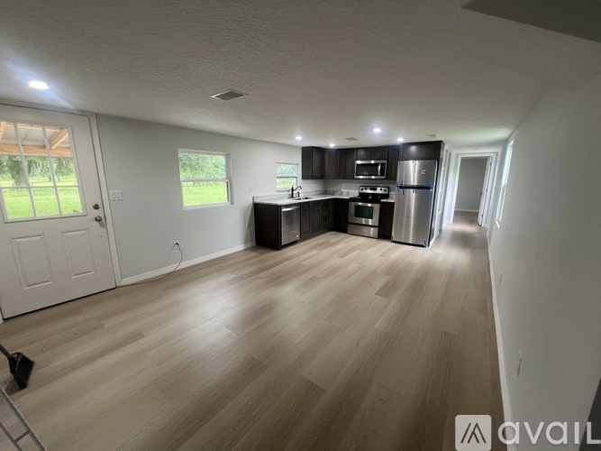A kitchen with wooden floors and stainless steel appliances.