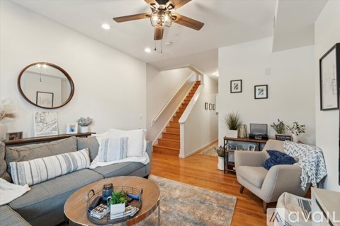 A living room with a grey couch and a coffee table.