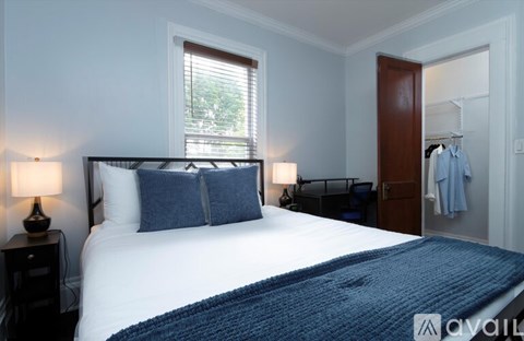 A bedroom with a large bed and a blue blanket.