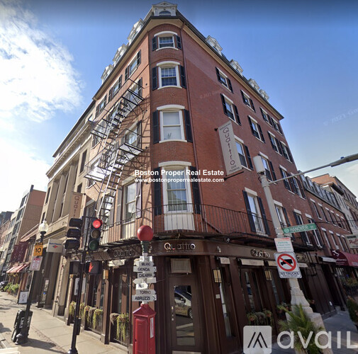 A red brick building with a fire escape on the side.