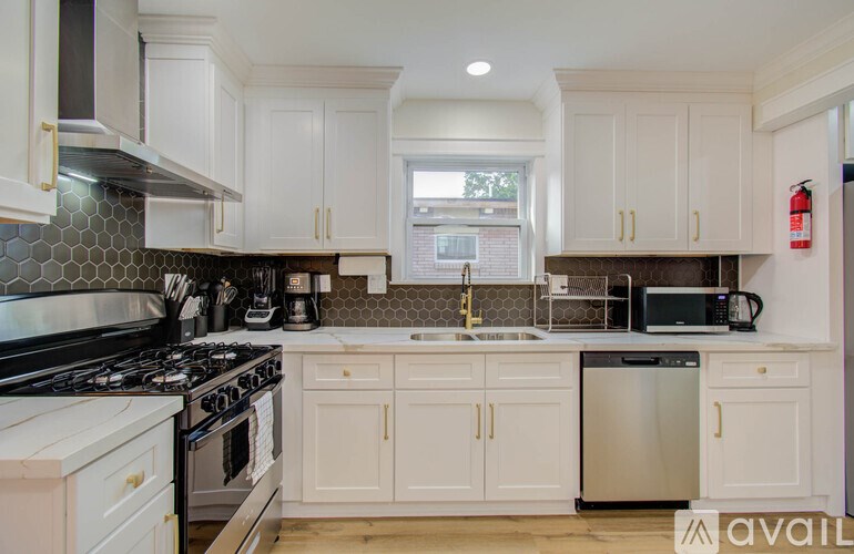 A kitchen with white cabinets and a black stove top.