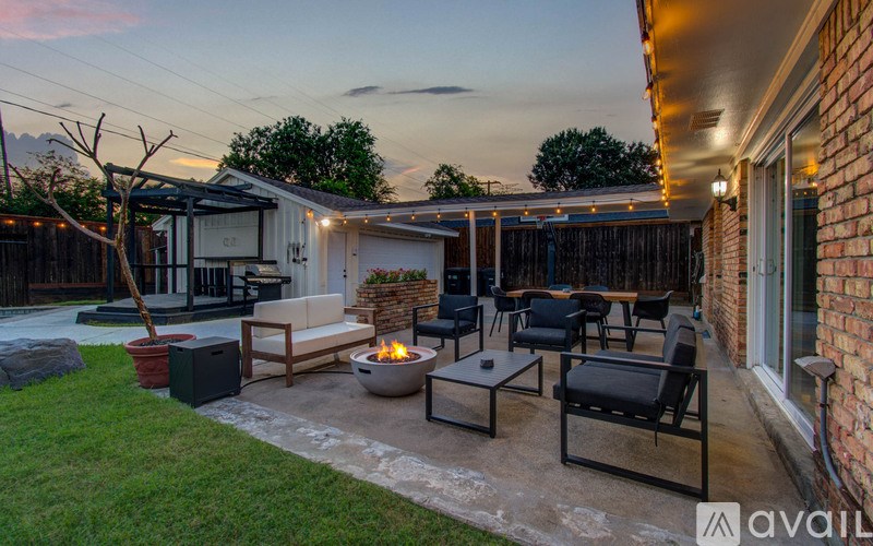 A backyard with a fire pit and seating area.
