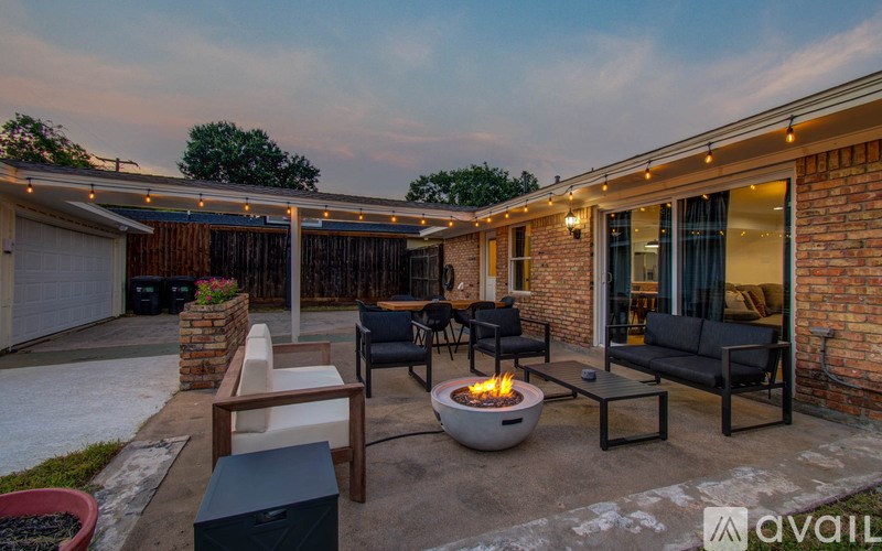 A backyard with a fire pit and seating area.