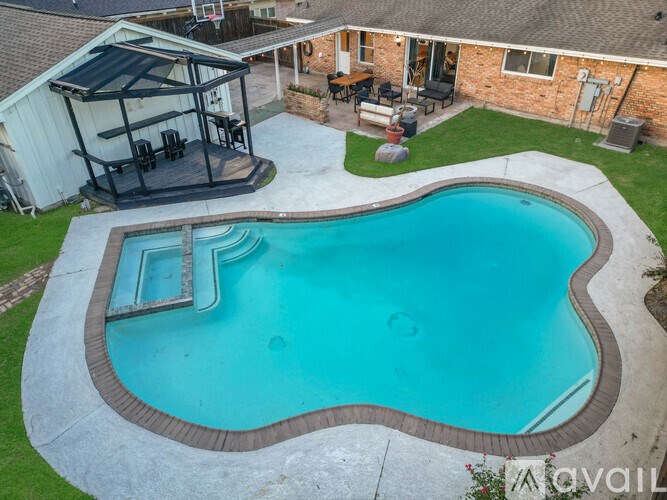 A small residential pool with a slide.