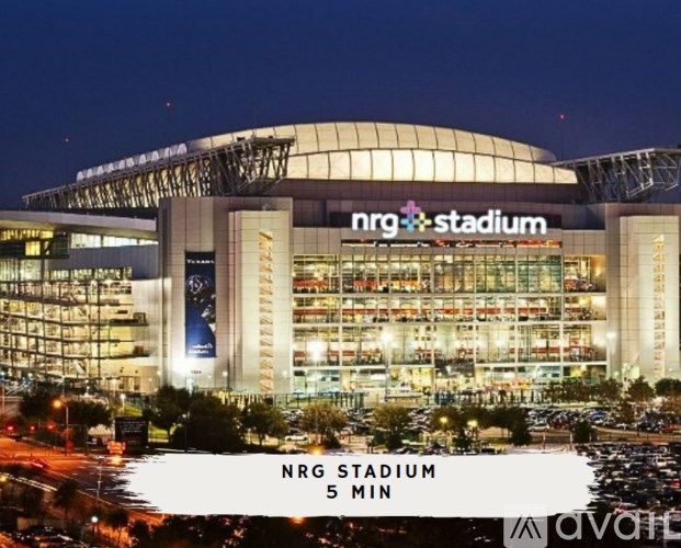 NRG Stadium is a large, modern building with a glass facade and a curved roof.