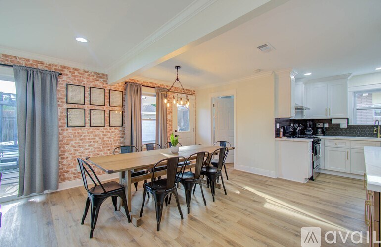 A dining room with a wooden table and chairs.