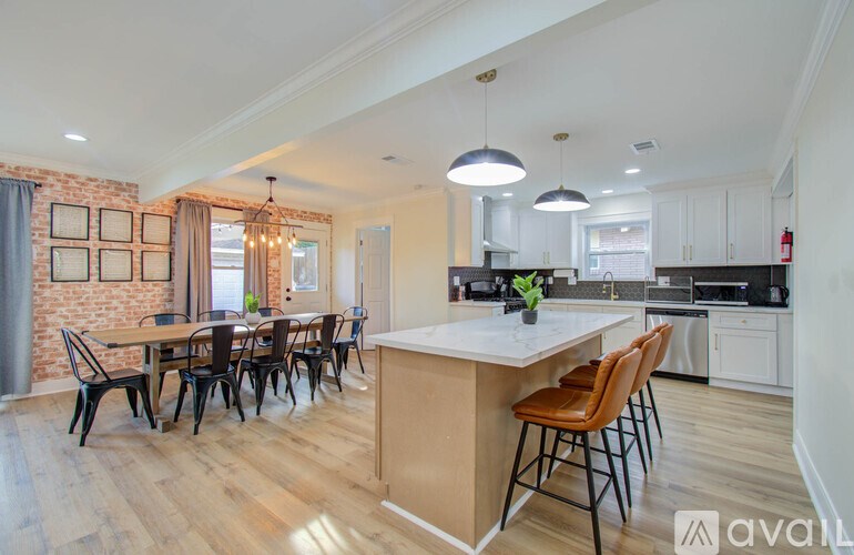 A kitchen with a dining table and chairs.