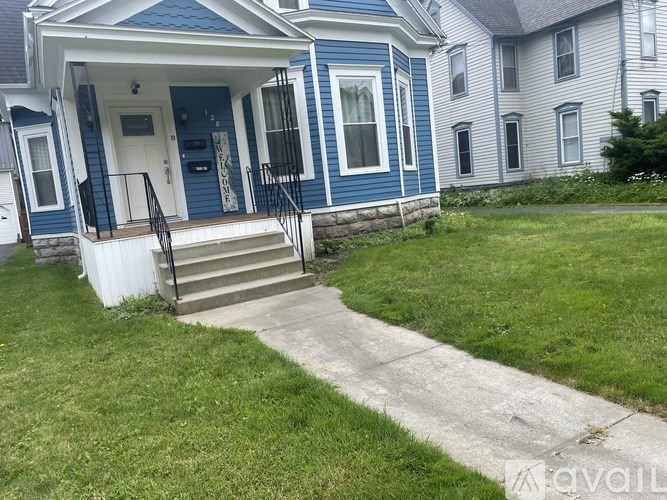 A blue house with a white door and windows.