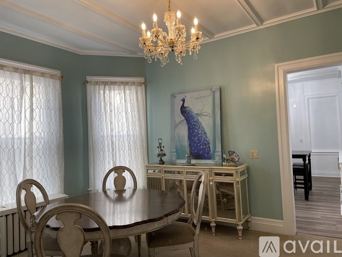 A dining room with a wooden table and chairs.