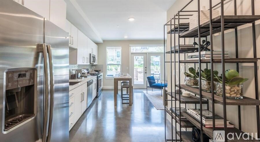 A modern kitchen with stainless steel appliances and a bar area.