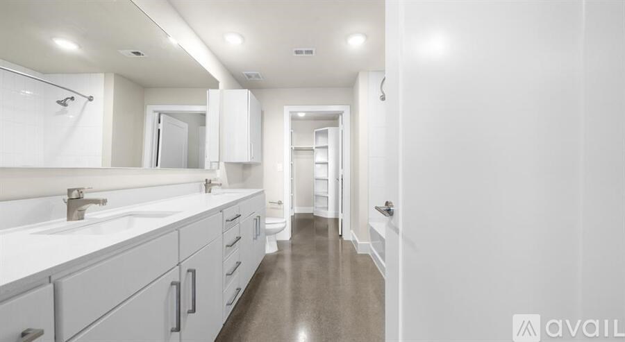 A bathroom with a sink, mirror, and cabinets.