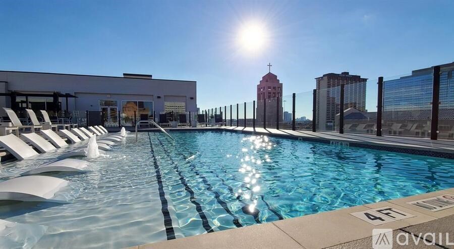 A sunny day at the pool with a view of the city skyline.