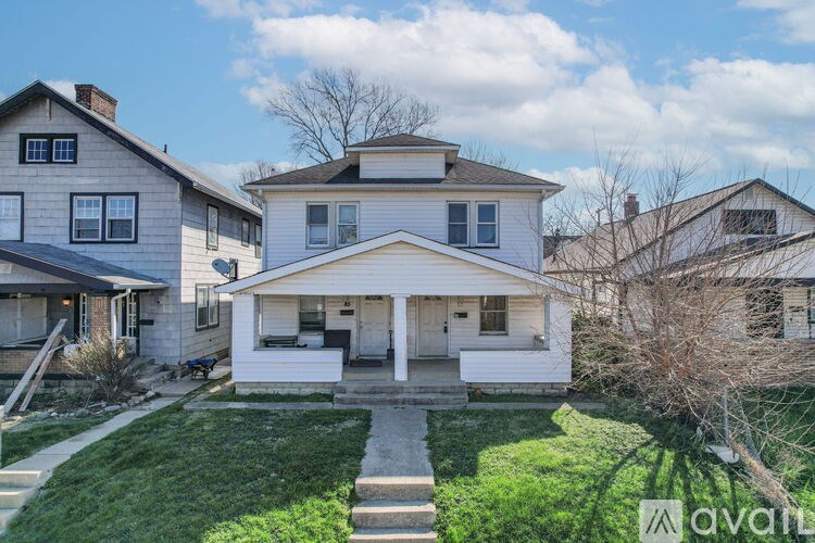 A house with a front yard is for sale.