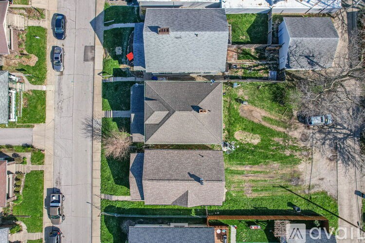 A bird's eye view of a residential area with houses and cars.