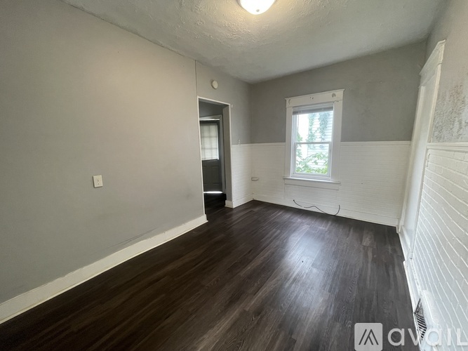 A room with wooden floors and a window.