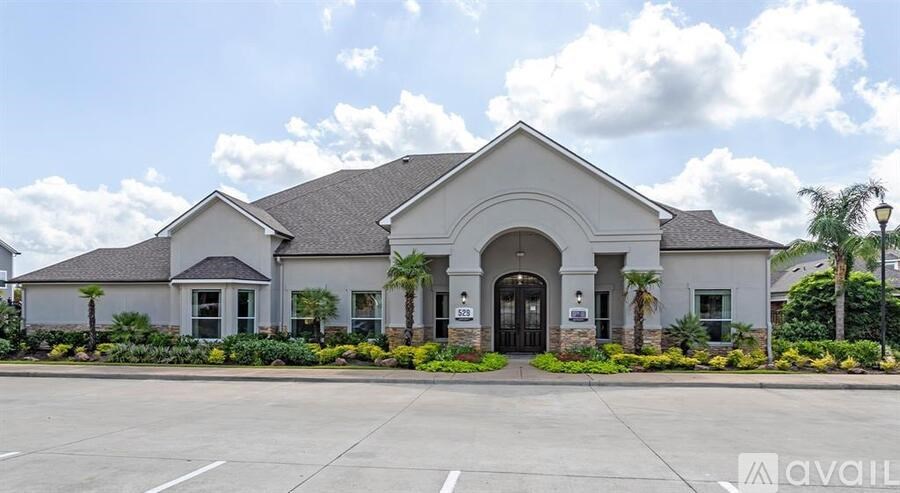 A building with a large front yard and a sign that says "available" in the foreground.