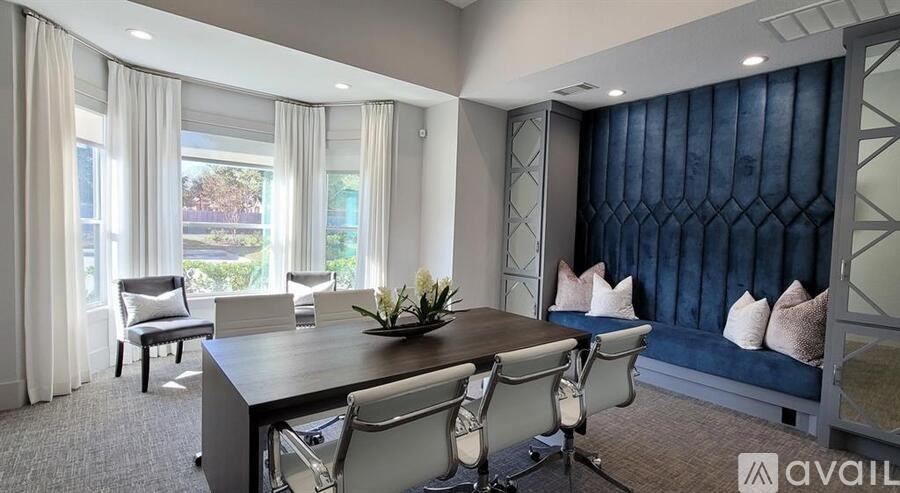 A modern living room with a large table and chairs.