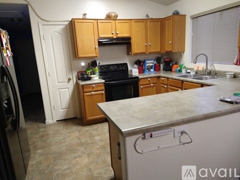 A kitchen with wooden cabinets and a black oven.