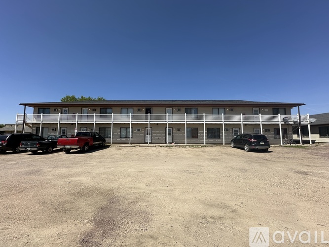 A building with a parking lot in front of it.