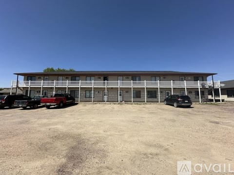 A building with a parking lot in front of it.