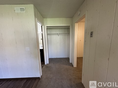 A room with white walls and a carpeted floor.