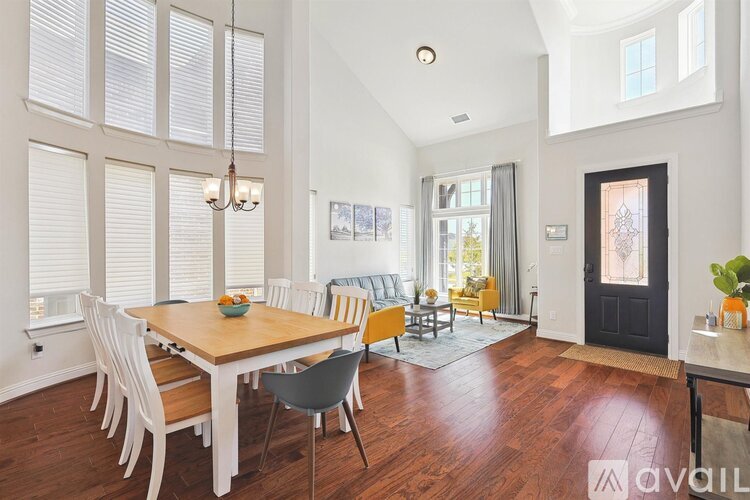 A dining room with a wooden table and chairs.