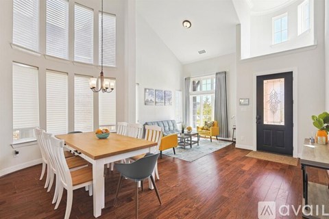 A dining room with a wooden table and chairs.