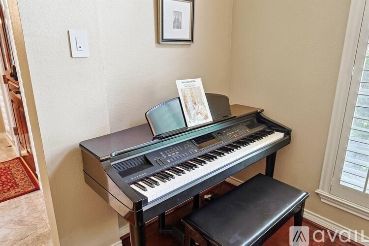 A black piano with a music stand on it.
