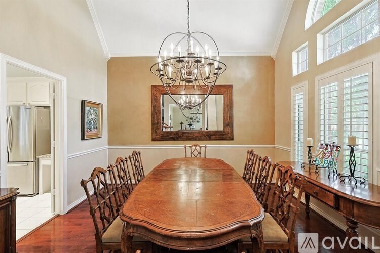 A dining room with a wooden table and chairs.