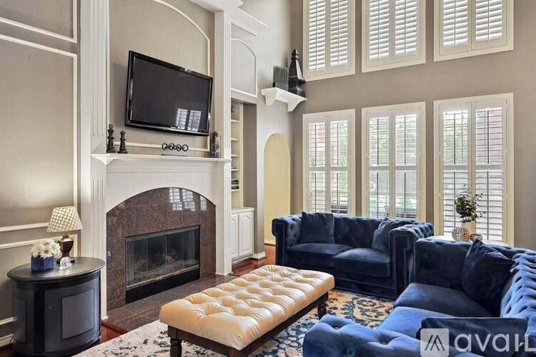 A living room with a fireplace, a television, and a couch.