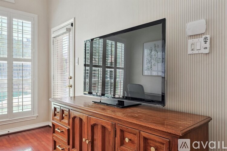 A wooden cabinet with a flat screen TV on top of it.